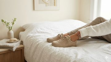 Light-coloured shoes sitting neatly in a bright home, representing how to get rid of damp smell in shoes without throwing them out