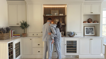 Couple in a bright, moisture-free kitchen showing the benefits of preventing moisture in the home