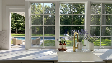 Bright sunlit room with open windows and spring decor representing the ideal time for spring cleaning your wardrobe in Australian homes